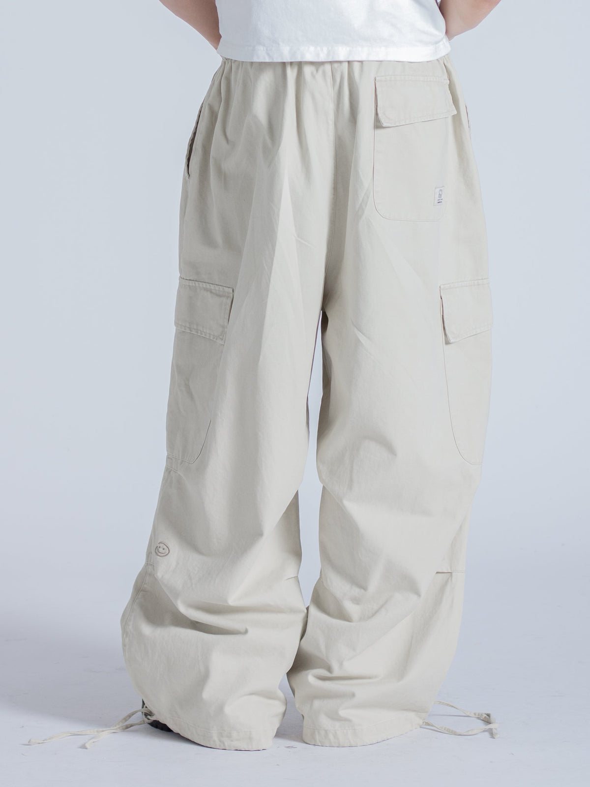 SMILEY LOGO PARACHUTE PANTS - LIGHT BEIGE